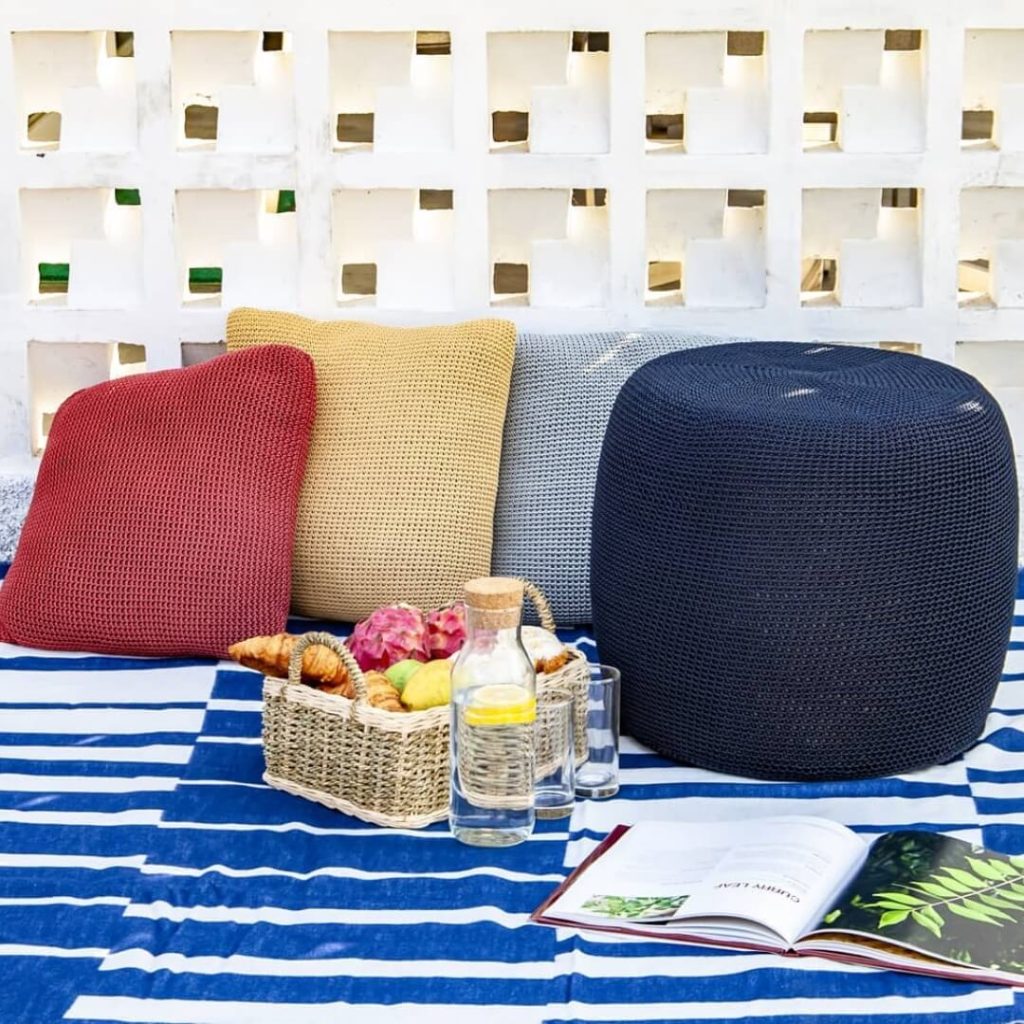 outdoor poufs and pillows on a patio set