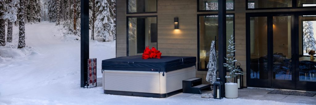 Hot tub with Christmas holiday bow in a winter outdoor backyard scene