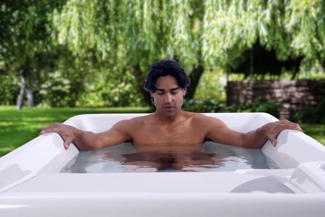 man sitting in cold plunge tub
