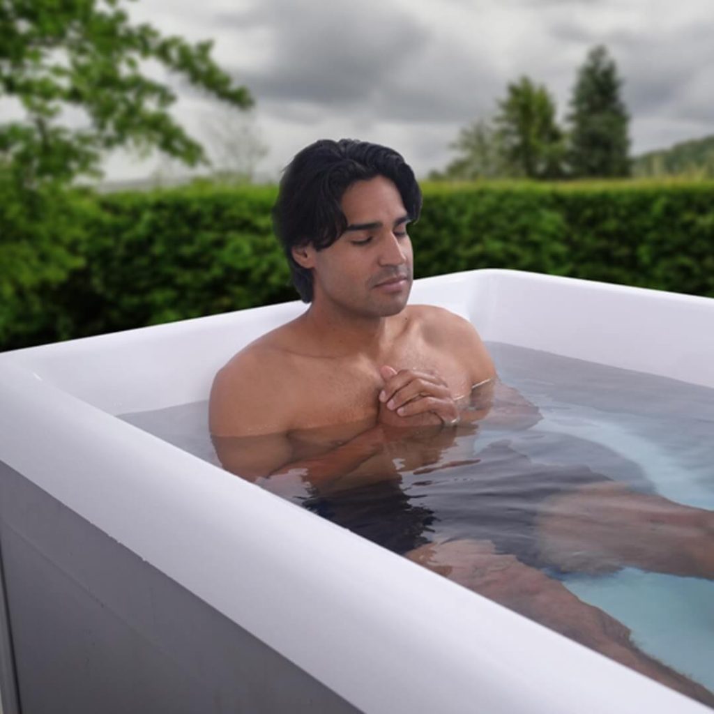 man sitting in a cold plunge tub